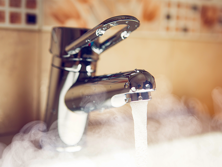 Hot water running from faucet