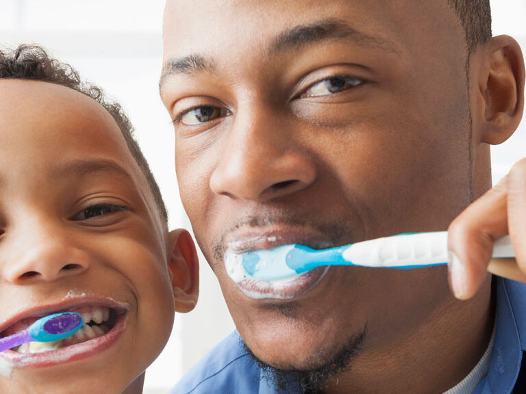 father son brushing