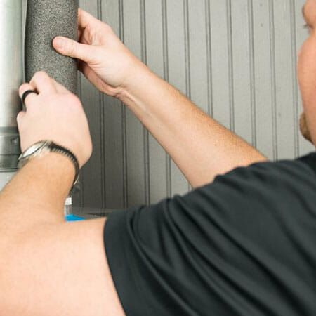 man working on water heater