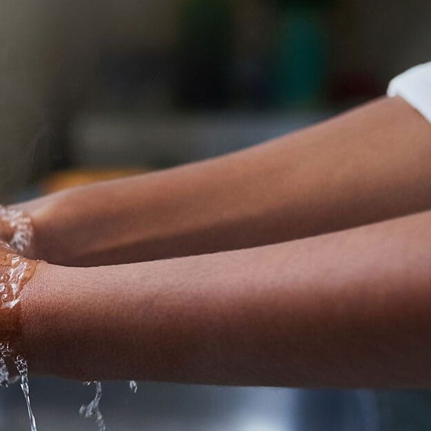 washing hands at sink