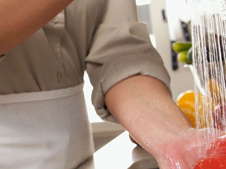 washing vegetables in sink