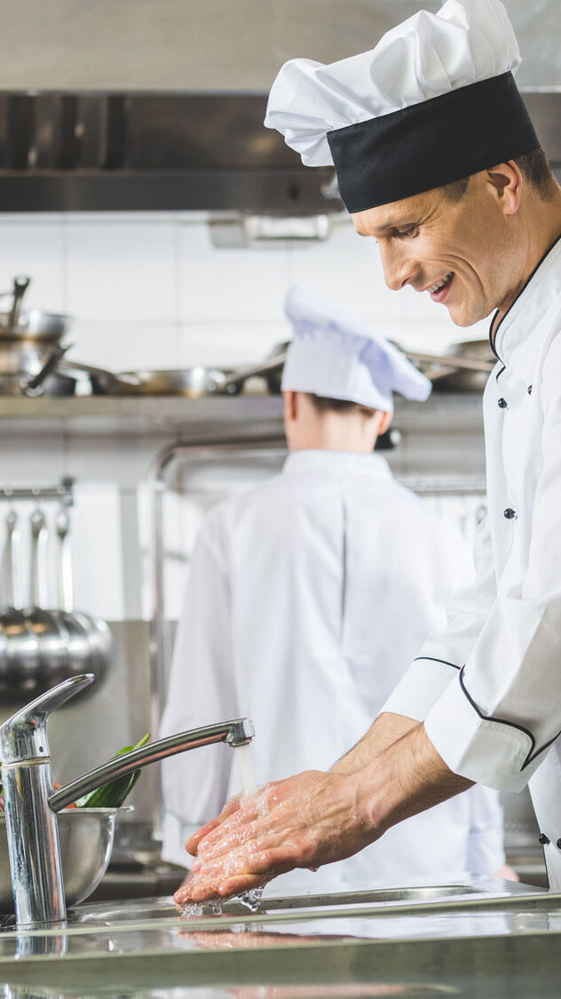 Chefs cooking in a commercial kitchen Chefs cooking in a commercial kitchen
