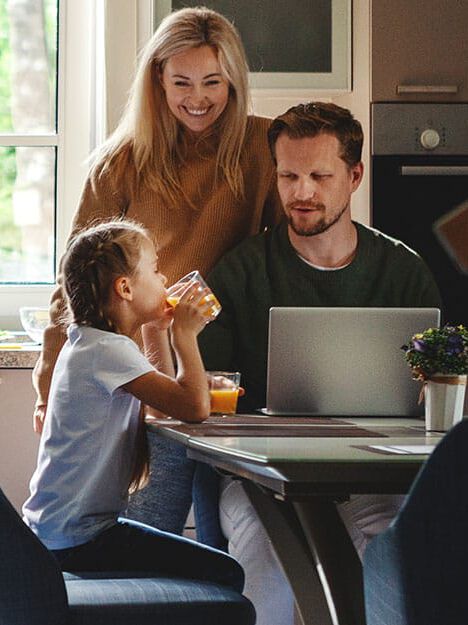 family smiling at sink